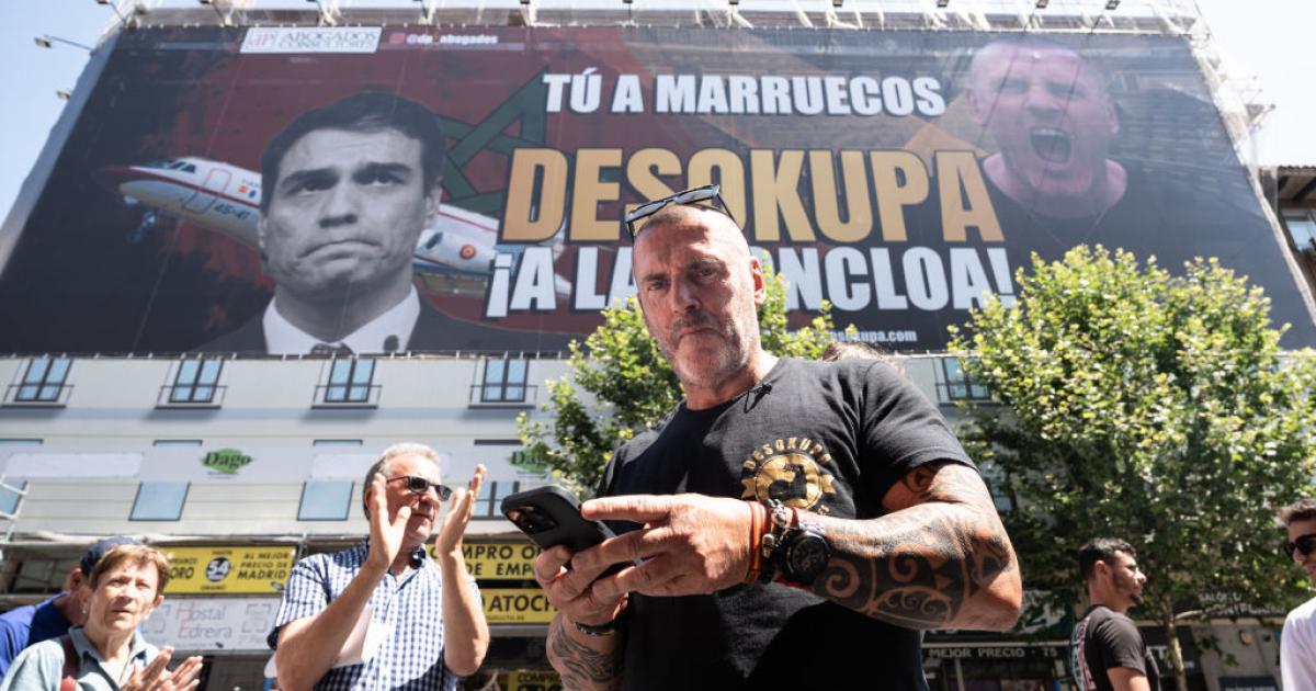 El líder de Desokupa, Dani Esteve, ante la lona colocada en Madrid contra el presidente del Gobierno.