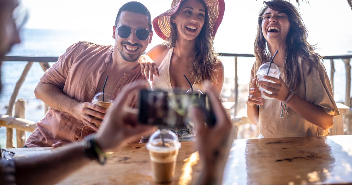 Imagen de un grupo de amigos tomándose una foto en un chiringuito de playa.