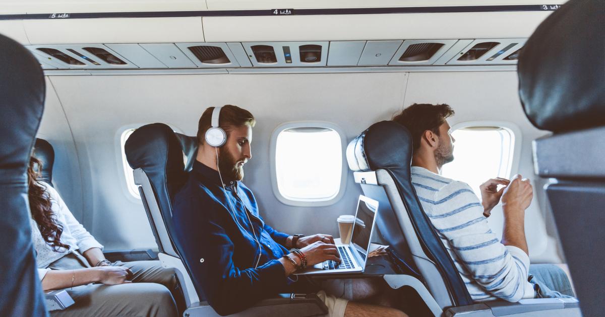 Un pasajero usa su ordenador portátil durante un vuelo.