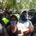 Dos manifestantes, con pañuelos en sus rostros, durante la manifestación.