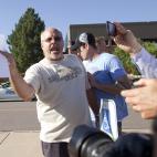 Tom Sullivan , holds a photograph of his son, Alex Sullivan, as he pleads with the media to help him find his son, outside Gateway High School on Friday, July 20, 2012 in Aurora, Colo. Alex Sullivan, was celebrating his 27th birthday by attendin...