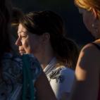 A woman cries outside Gateway High School where witness were brought for questioning after a gunman opened fire at a midnight premiere of The Dark Knight Rises Batman movie Friday, July 20, 2012 in Aurora, Colo. A gunman wearing a gas mask set o...