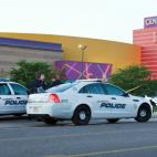 Police cars in front of the Century 16 theater in Aurora, Colorado where a gunman opened fire during the opening of the new Batman movie "The Dark Knight Rises" killing at least 15 people and wounding 50 others on the morning of July 20, 2012. ...