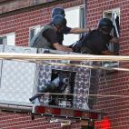 Police use a video camera to look inside an apartment where the suspect in a shooting at a movie theatre lived in Aurora, Colo., Friday, July 20, 2012. As many as 12 people were killed and 50 injured at a shooting at the Century 16 movie theatr...