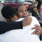 Shamecca Davis hugs her son Isaiah Bow, who was an eye witness to the shooting, outside Gateway High School where witness were brought for questioning Friday, July 20, 2012 in Denver. After leaving the theater Bow went back in to find his girlf...