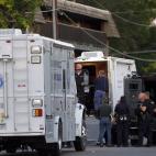 Police gather near an apartment house where the suspect in a shooting at a movie theatre lived in Aurora, Colo., Friday, July 20, 2012. As many as 12 people were killed and 50 injured at a shooting at the Century 16 movie theatre early Friday du...