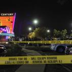 People gather outside the Century 16 movie theatre in Aurora, Colo., at the scene of a mass shooting early Friday morning, July 20, 2012. Police Chief Dan Oates says 12 people are dead following the shooting at the suburban Denver movie theater...