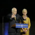 Sen. John McCain, R-Ariz., gestures to his supporters, while his wife, Cindy looks on during his concession speech at the Arizona Biltmore in Phoenix, Tuesday, Nov. 4, 2008. (AP Photo/Elise Amendola)