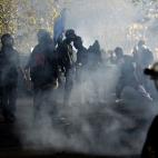 Demonstrators throw projectiles to riot policemen during a protest on a day of mobilisation against austerity measures by workers in southern Europe on November 14, 2012 in Rome. Riot police and anti-austerity protesters clashed in Italy on Wedn...
