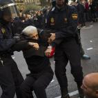 Riot police apprehend a protestor during a general strike in Madrid, Spain, Wednesday, Nov. 14, 2012. Spain's General Workers' Union said the nationwide stoppage, the second this year, was being observed by nearly all workers in the automobile, ...