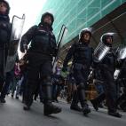 Riot policemen march in front of demonstrators during a protest on a day of mobilisation against austerity measures by workers in southern Europe on November 14, 2012 in Rome. Thousands of people took to the streets of major cities including Mil...