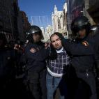 Riot police arrest a protestor during a general strike in Madrid, Spain, Wednesday, Nov. 14, 2012. Spain's General Workers' Union said the nationwide stoppage, the second this year, was being observed by nearly all workers in the automobile, ene...