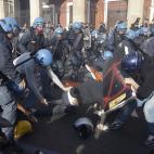 Demonstrators clash with policemen in riot gear during a protest against Italian Government austerity measures in Rome, Wednesday, Nov. 14, 2012. Workers across the European Union sought to present a united front against rampant unemployment and...