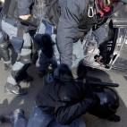 Demonstrators clash with riot police during a protest against Italian Government austerity measures in Rome, Wednesday, Nov. 14, 2012. Workers across the European Union sought to present a united front against rampant unemployment and government...