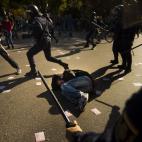 A protestor lies on the ground during clashes with riot police in a general strike in Madrid, Spain, Wednesday, Nov. 14, 2012. Spain's General Workers' Union said the nationwide stoppage, the second this year, was being observed by nearly all wo...