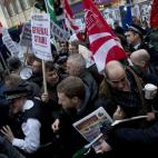 Police officers try to push protesters back onto the pavement after they blocked traffic on Oxford Street, London, whilst taking part in a picket and demonstration they said was over dismissals of 28 workers employed by contractors on the Crossr...
