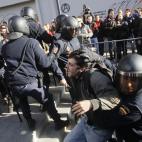Police riots apprehend a protestor during a general strike in Madrid, Spain, Wednesday, Nov. 14, 2012. Spain's General Workers' Union said the nationwide stoppage, the second this year, was being observed by nearly all workers in the automobile,...