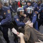 Police riots arrest a protestor during a general strike in Madrid, Spain, Wednesday, Nov. 14, 2012. Spain's main trade unions stage a general strike, coinciding with similar work stoppages in Portugal and Greece, to protest government-imposed au...