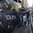 Riot police arrest a protestor during a general strike in Madrid, Spain, Wednesday, Nov. 14, 2012. Spain's main trade unions stage a general strike, coinciding with similar work stoppages in Portugal and Greece, to protest government-imposed aus...
