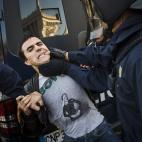 Riot police apprehend a protestor during a general strike in Madrid, Spain, Wednesday, Nov. 14, 2012. Spain's General Workers' Union said the nationwide stoppage, the second this year, was being observed by nearly all workers in the automobile, ...