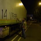 A protester paints a graffiti to a truck reading "14 Strike" at the main entrance to Mercabarna, the biggest wholesale market, during a general strike in Barcelona, Spain, Wednesday, Nov. 14, 2012. Spain's main trade unions will stage a general ...