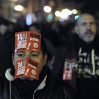 A protester marches with his face covered with flyers reading "They leave us without future, Nov. 14 general strike" during a general strike in Madrid, Spain, Wednesday, Nov. 14, 2012. Spain's main trade unions stage a general strike, coinciding...