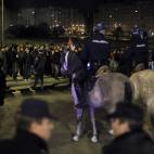 Protestors try to stop buses to run as the police stand guard outside a main bus garage during a general strike in Madrid, Spain, Wednesday, Nov. 14, 2012. Spain's main trade unions stage a general strike, coinciding with similar work stoppages ...