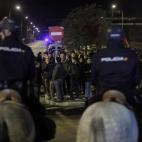 Protestors try to stop buses to run as the police stand guard outside a main bus garage during a general strike in Madrid, Spain, Wednesday, Nov. 14, 2012. Spain's main trade unions stage a general strike, coinciding with similar work stoppages ...