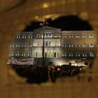 The Greek Parliament is seen through a banner during demonstration against austerity measures in Athens on November 11, 2012. Thousands of protesters massed outside Greece's parliament Sunday as lawmakers prepared to vote on a 2013 budget that ...