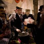 Anti-austerity protesters take part in what they called 'the Plebs & PIIGS Banquet', a demonstration outside the Lord Mayor's Banquet in the City of London, Monday, Nov. 12, 2012. PIIGS is a reference to people from Portugal, Italy, Ireland, Gre...