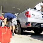 Robin Robert of Metairie fuels up gas cans for his generator as he and other residents head to the pumps in preparation for Tropical Storm Issac in Metairie, Louisiana, August 27, 2012. On its current track, Isaac was due to slam into the Gulf C...