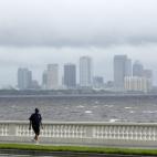 Un ciudadano de Tampa camina a lo largo del boulevard de la bahía de la ciudad, con el mar revuelto a sus espaldas.