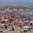 Numerosas personas aprovechan para bajarse a la playa de la Malvarosa y poder darse un baño