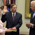 WASHINGTON, DC - SEPTEMBER 06: Vice President Joseph Biden (R) swears in David Petraeus (C) to be Director of the Central Intelligence Agency, while his wife Holly Petraeus holds a Bible, in the Roosevelt Room at the White House, on September 6...