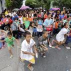 Un grupo de niños corre durante un programa de regalos de Navidad en un área pobre de Las Pinas al sur de Manila, Filipinas. Los Filipinos celebran la Navidad más larga del mundo empezando a celebrar las festividades a finales de septiembre.