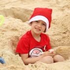 Se puede ser navideño pese a estar en la playa, como hace este niño en Sidney, en una playa australiana.
