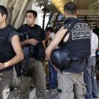In this Aug. 9, 2012 photo, Lebanese security forces stand at the entrance building of former Lebanese Information Minister Michel Samaha as they raid his house after they arrested him. Samaha an ardent supporter of President Bashar Assad who ha...