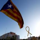An Estelada (Catalan separatist flag) flutters next to a yellow ribbon as Catalan pro-independence demonstrators attend a protest to call for the release of jailed separatist leaders in Barcelona, Spain, October 26, 2019. REUTERS/Sergio Perez
