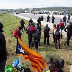 Spanish riot police evacuates Catalan separatists after breaking up a blockade on AP-7 motorway linking Spain to neighbouring France, near Figueras on March 27, 2018. Spanish riot police broke up a blockade by Catalan separatists on major motorw...