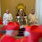 In this photo provided by the Vatican newspaper L'Osservatore Romano, Pope Benedict XVI, center, reads a document in Latin where he announces his resignation, during a meeting of Vatican cardinals, at the Vatican, Monday, Feb. 11, 2013. Benedict...