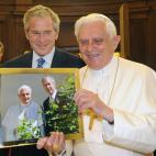 Pope Benedict XVI receives a picture from US President George W. Bush during a tete-a-tete in the medieval St John's Tower in the Vatican Gardens on June 13, 2008. US President George W. Bush had a special audience with Pope Benedict XVI, who wa...