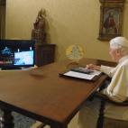 In this photo released by the Vatican newspaper Osservatore Romano, Pope Benedict XVI, seated in his studio at the Vatican City, uses an iPad device to light up one of the world's largest electronic Christmas trees in Gubbio, central Italy, Wedn...