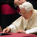 Pope Benedict XVI clicks on a tablet to send his first twitter message during his weekly general audience on December 12, 2012 at the Paul VI hall at the Vatican. Pope Benedict XVI sent his first Twitter message from a digital tablet on Wednesda...