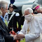 Pope Benedict XVI (R) is greeted by Italian Prime Minister Mario Monti and his wife Elsa (L) as he disembarks from a helicopter in Arezzo stadium on the start of a one day pastoral visit on May 13, 2012. The Pope will lead a Holy Mass and will a...