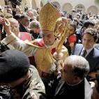 FILE - In this Tuesday, March 15, 2011 file photo, the newly elected Maronite Patriarch Bechara el-Rai gestures as he is surrounded by supporters shortly after his election at the Maronite church's seat in Bkirki, northeast of Beirut, Lebanon. P...