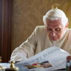 FILE - In this July 23, 2010 file photo made available by the Vatican newspaper L'Osservatore Romano, Pope Benedict XVI reads the L'Osservatore Romano newspaper in the pontiffs' summer residence in Castel Gandolfo, in the hills overlooking Rome....