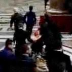 Grab taken from the Vatican TV shows French Cardinal Roger Etchegaray being carried away after getting injured as a woman threw herself at Pope Benedict XVI and dragged him to the ground as he entered St Peter's Basilica to celebrate Christmas E...