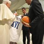 This handout picture released by The Vatican press office shows Pope Benedict XVI receiving a basketball jersey from former Italian basketball player Meneghin on December 16, 2009 after his weekly general audience at The Vatican. AFP PHOTO RES...