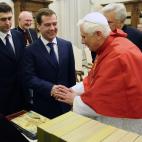 Pope Benedict XVI (R) exchanges presents with Russian President Dmitry Medvedev (C) during an audience at The Vatican on December 3, 2009. Russia and the Vatican have established full diplomatic relations ending longstanding tensions, the Kremli...