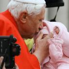 VATICAN CITY, Vatican: Pope Benedict XVI kisses a baby on St-Peter square at the Vatican during his weekly general audience, 21 December 2005. AFP PHOTO / VINCENZO PINTO (Photo credit should read VINCENZO PINTO/AFP/Getty Images)